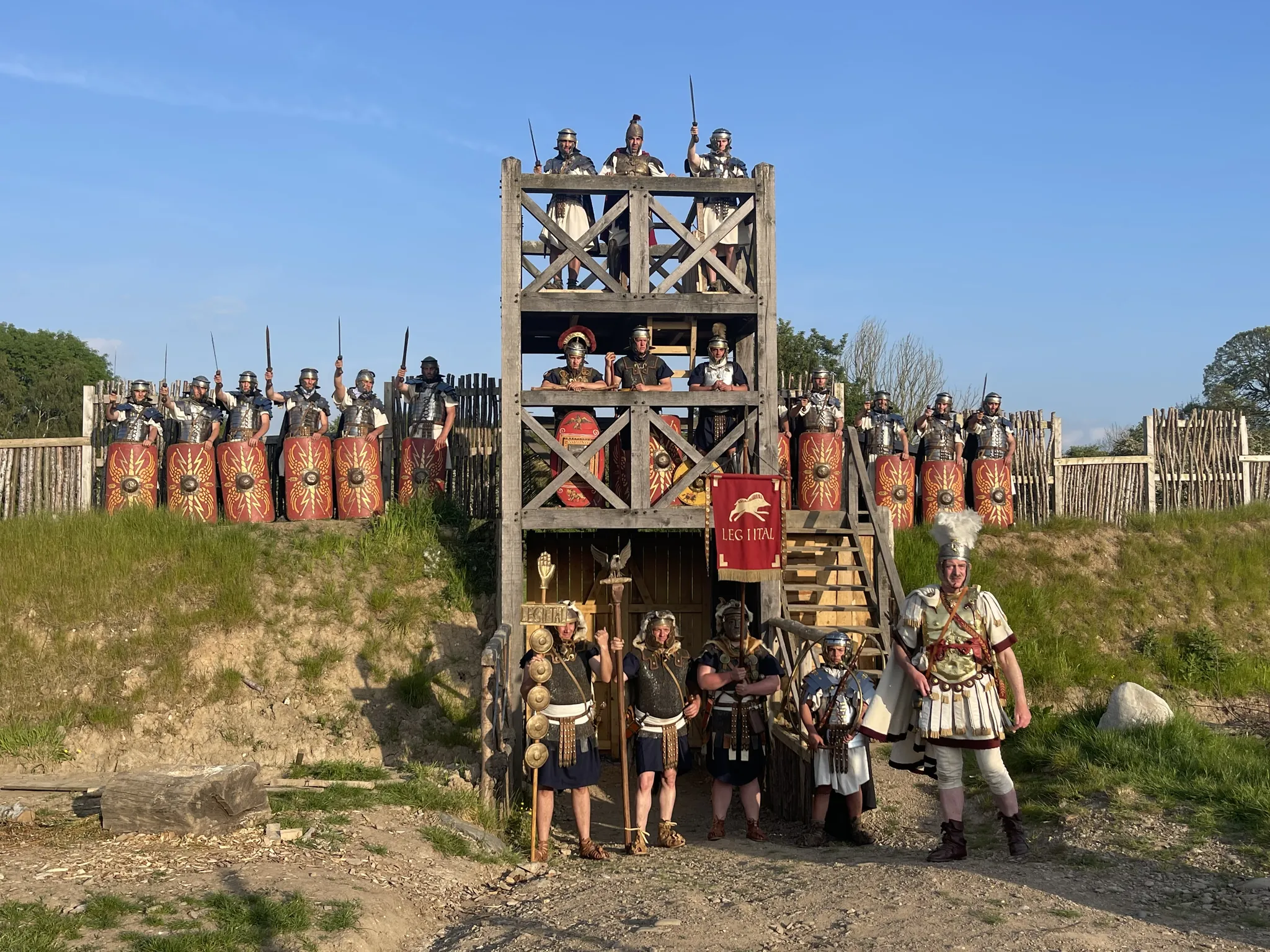 Roman auxiliaries with painted shields massed in front of the fort's timber gate-tower