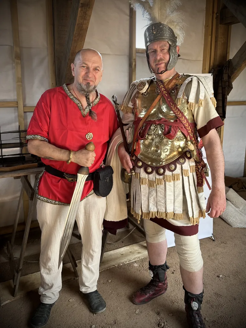 A Society member beside a re-enactor in full Roman officer's armour and crested helmet