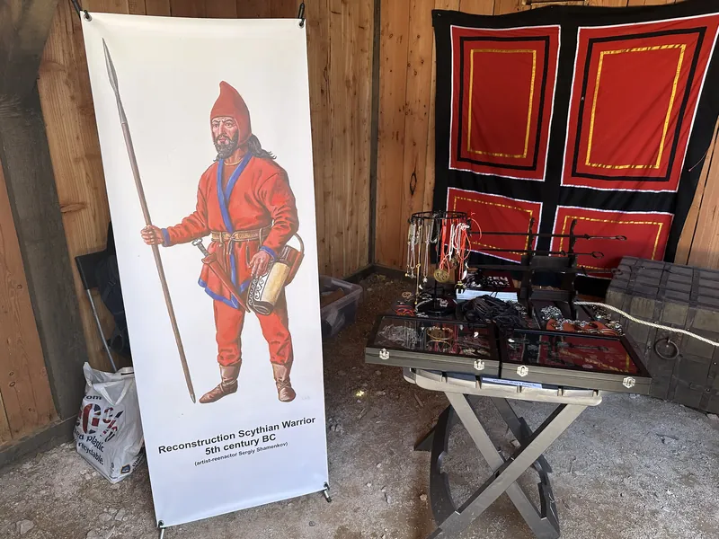 The Scythian warrior banner beside the display table and red painted shields