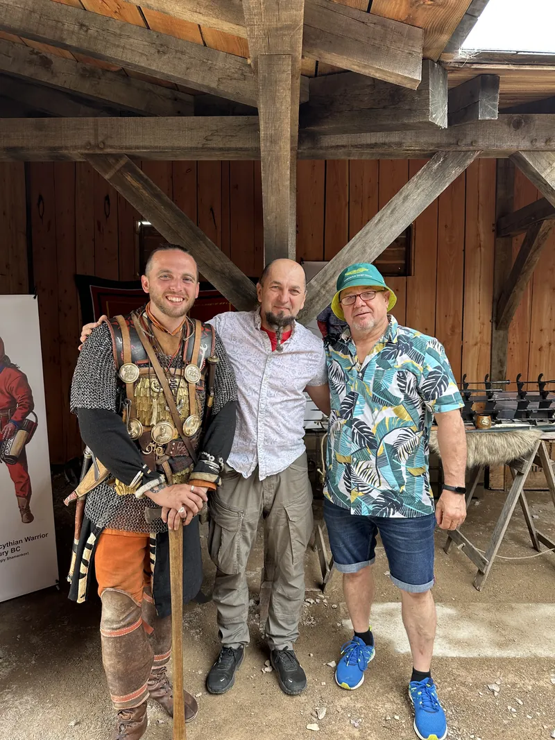 Three men photographed together, one in Sarmatian scale armour