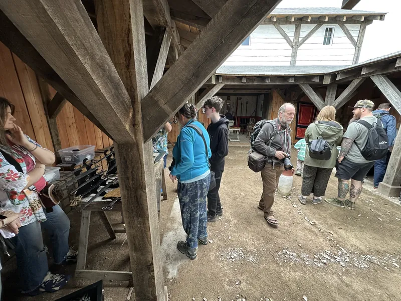Visitors gathered along the display tables in the timber hall