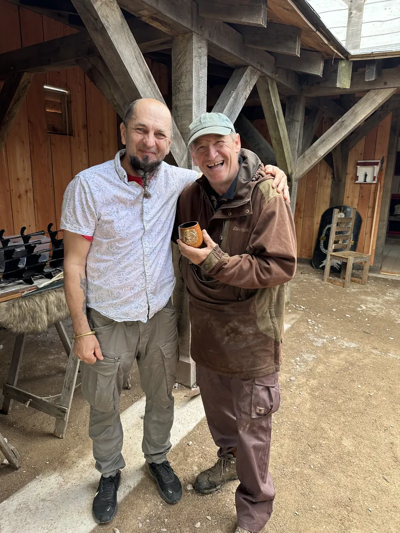 Two men photographed together in the timber hall