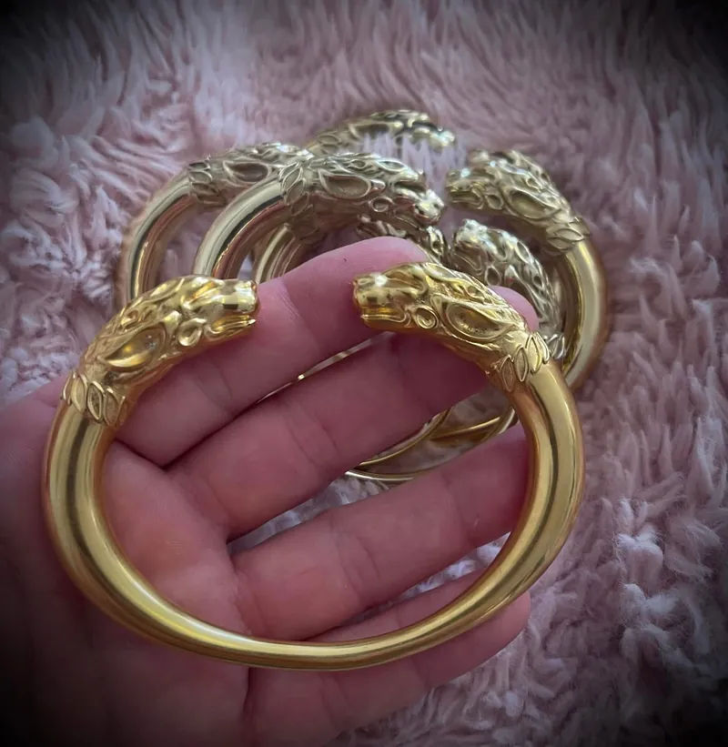 One of the bracelets held in an open hand to show its scale